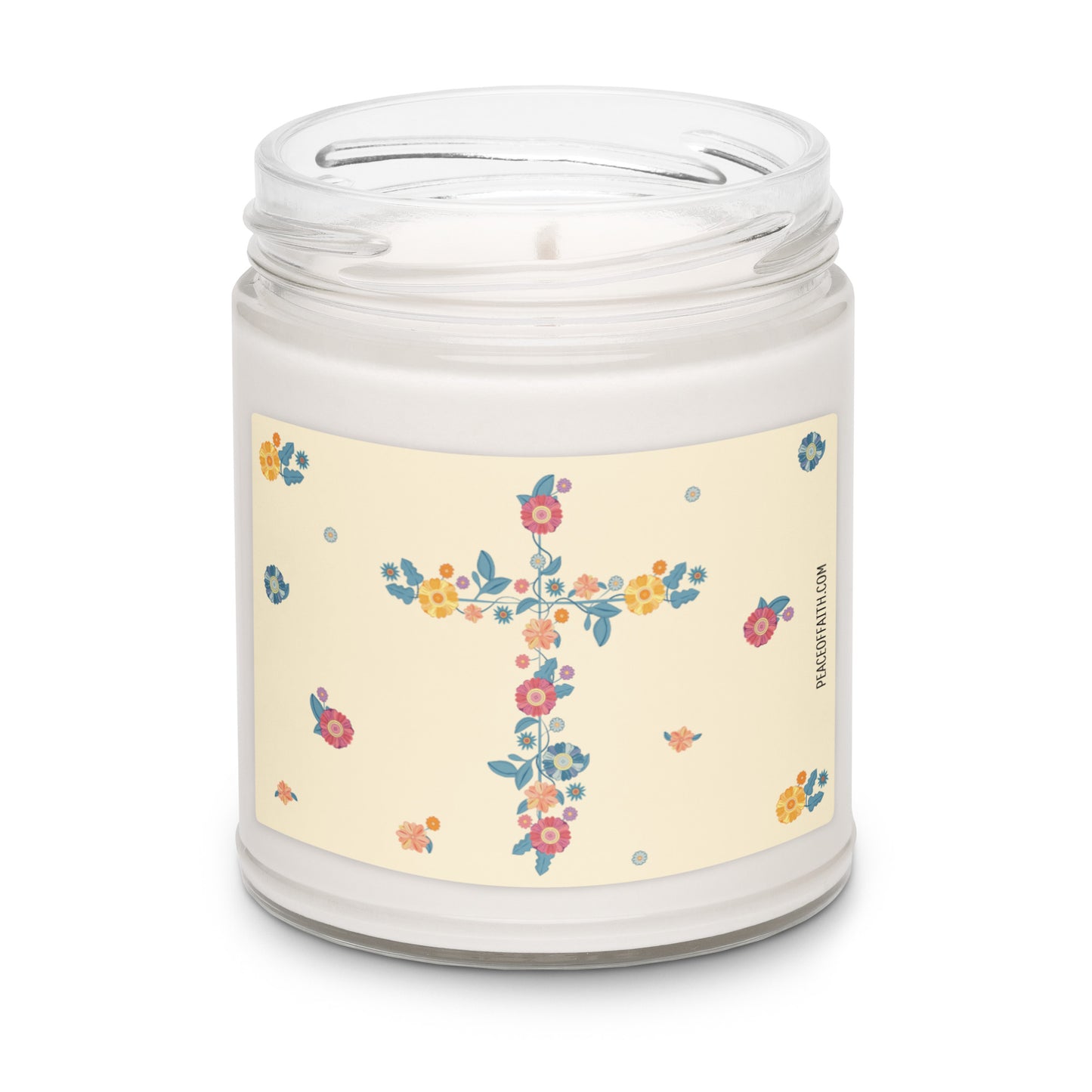 Clean cotton scented white soy candle with a label with a floral Christian cross and flowers scattered around.