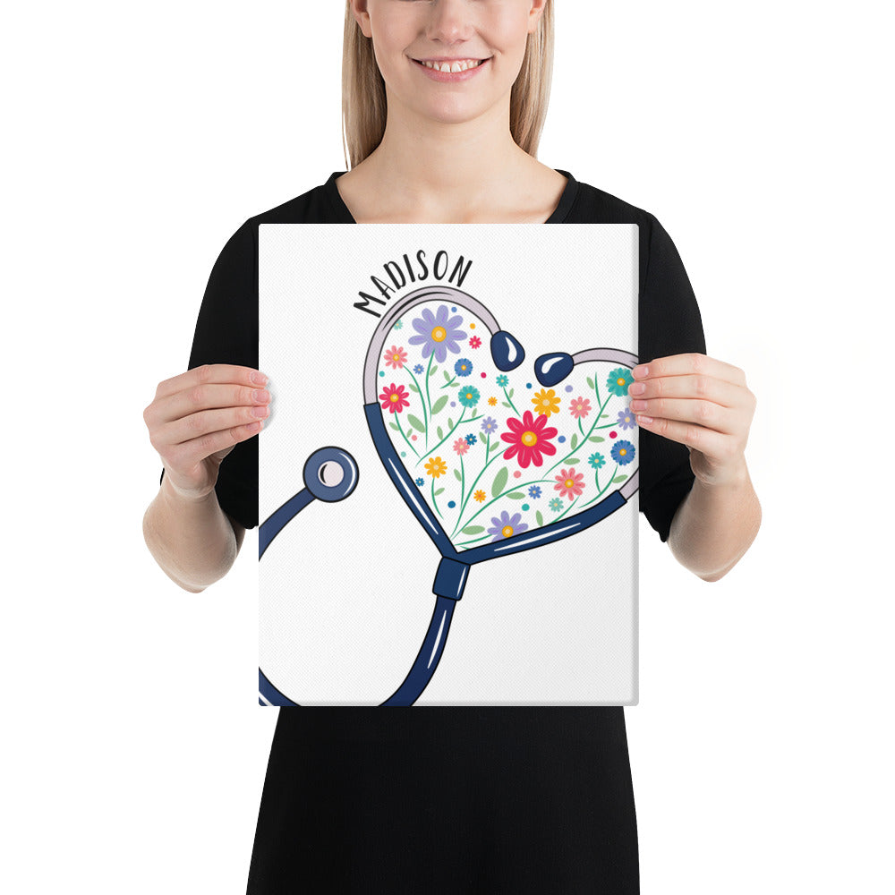 11x14 canvas print with a stethoscope in the shape of a heart with multi-colored flowers inside and personalized with a name hugging the top of the heart shape.