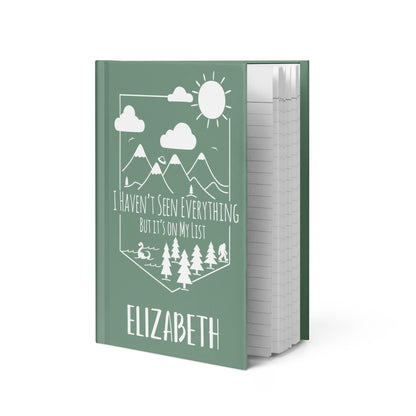 Personalized Adventure Travel Hardcover Journal with mountain scene with loch ness, alien spaceship & bigfoot with your name on the bottom. 
