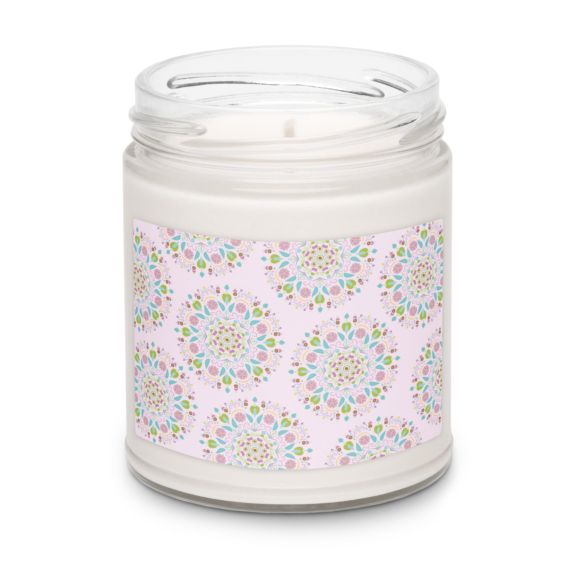 Apple harvest scented white soy candle in a clear glass jar with a label that has a light pink background and scattered with Scandinavian inspired mandalas.