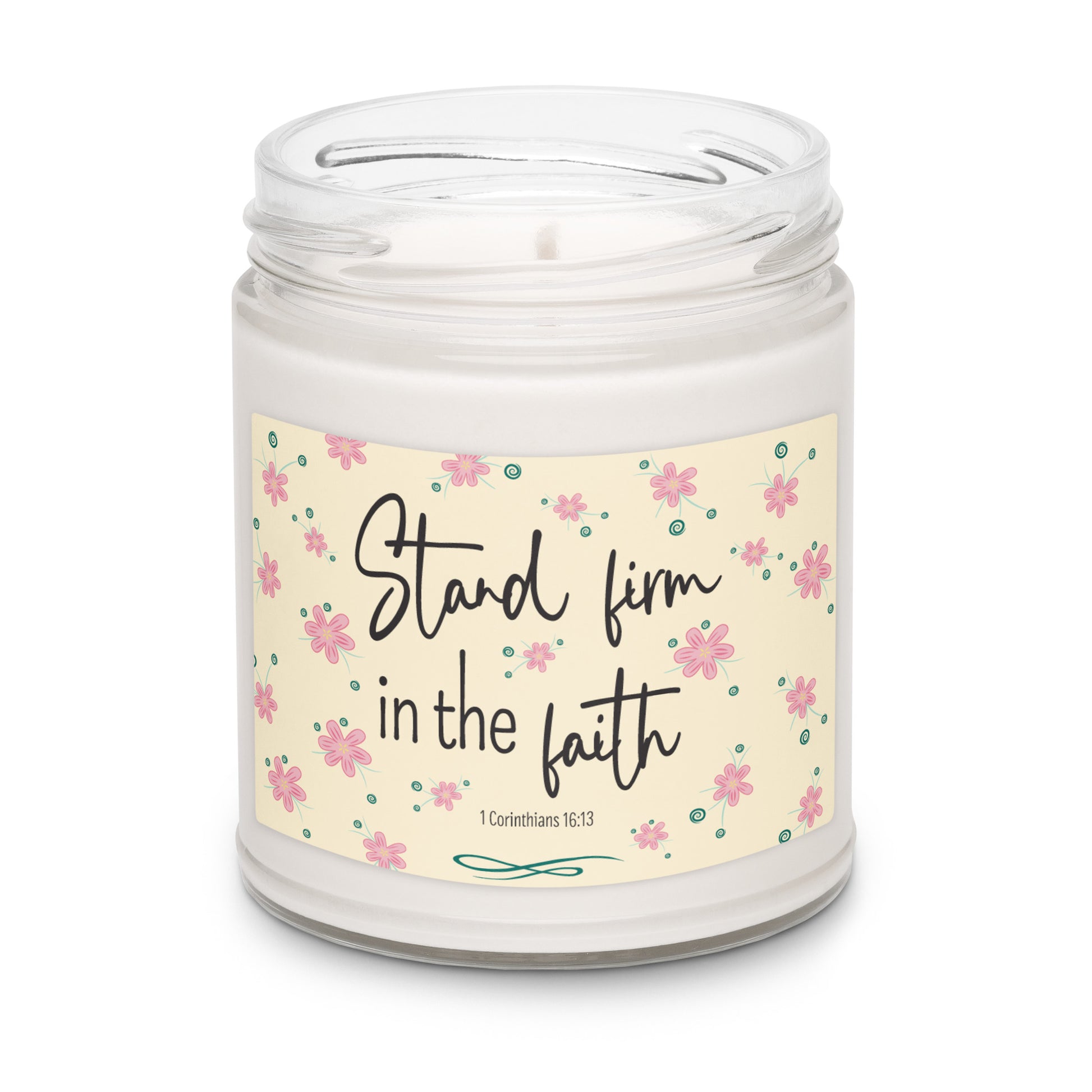 White apple harvest scented soy candle in a clear glass jar with a cream label and pink flowers that says "Stand firm in the faith, 1 Corinthians 16:13.