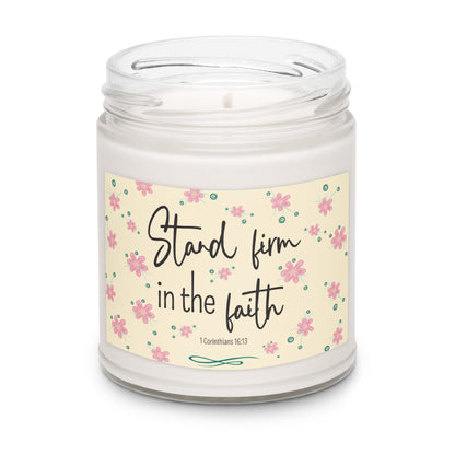 White apple harvest scented soy candle in a clear glass jar with a cream label and pink flowers that says "Stand firm in the faith, 1 Corinthians 16:13.