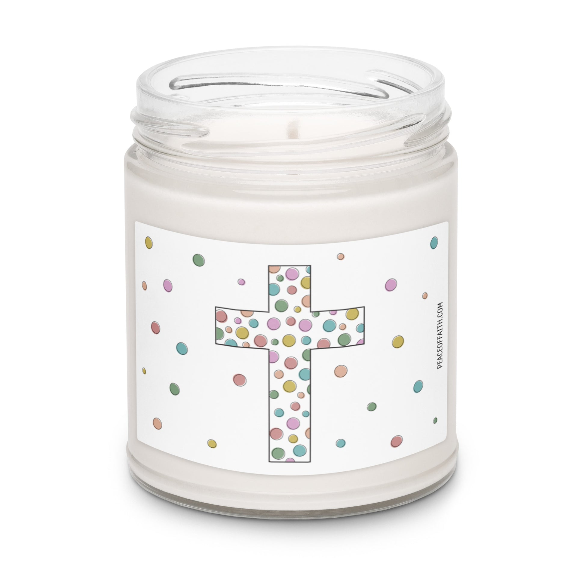 Clean cotton scented white soy candle with a label that has a multi colored polka dotted Christian cross with polka dots around. 
