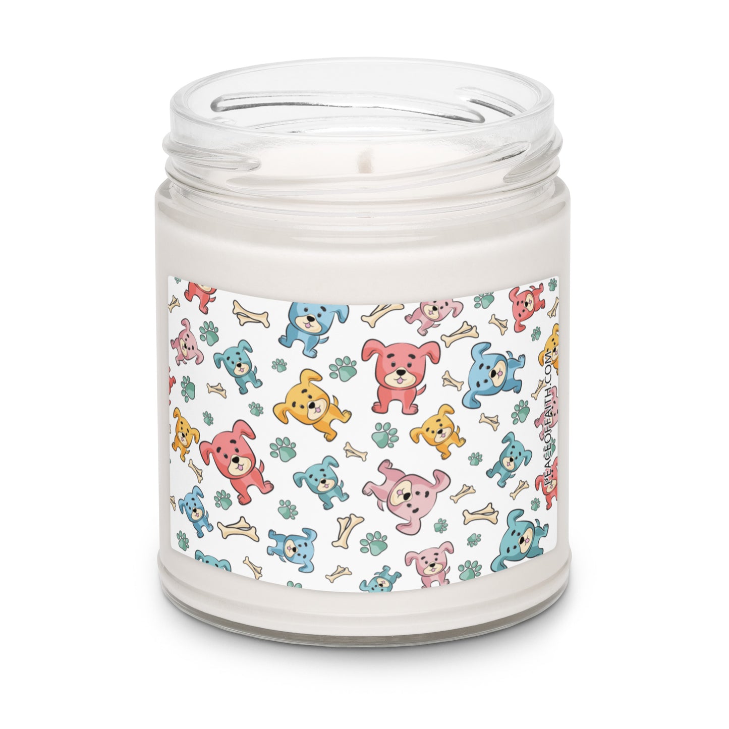 Clean cotton scented soy candle in a clear glass jar with multi-colored puppies with bones and paws tossed around on the front label.
