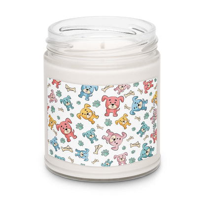 Clean cotton scented soy candle in a clear glass jar with multi-colored puppies with bones and paws tossed around on the front label.