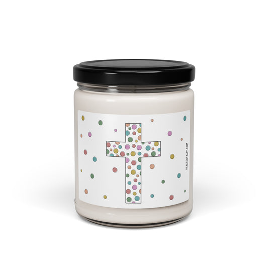 Clean cotton scented white soy candle with a label that has a multi colored polka dotted Christian cross with polka dots around. 