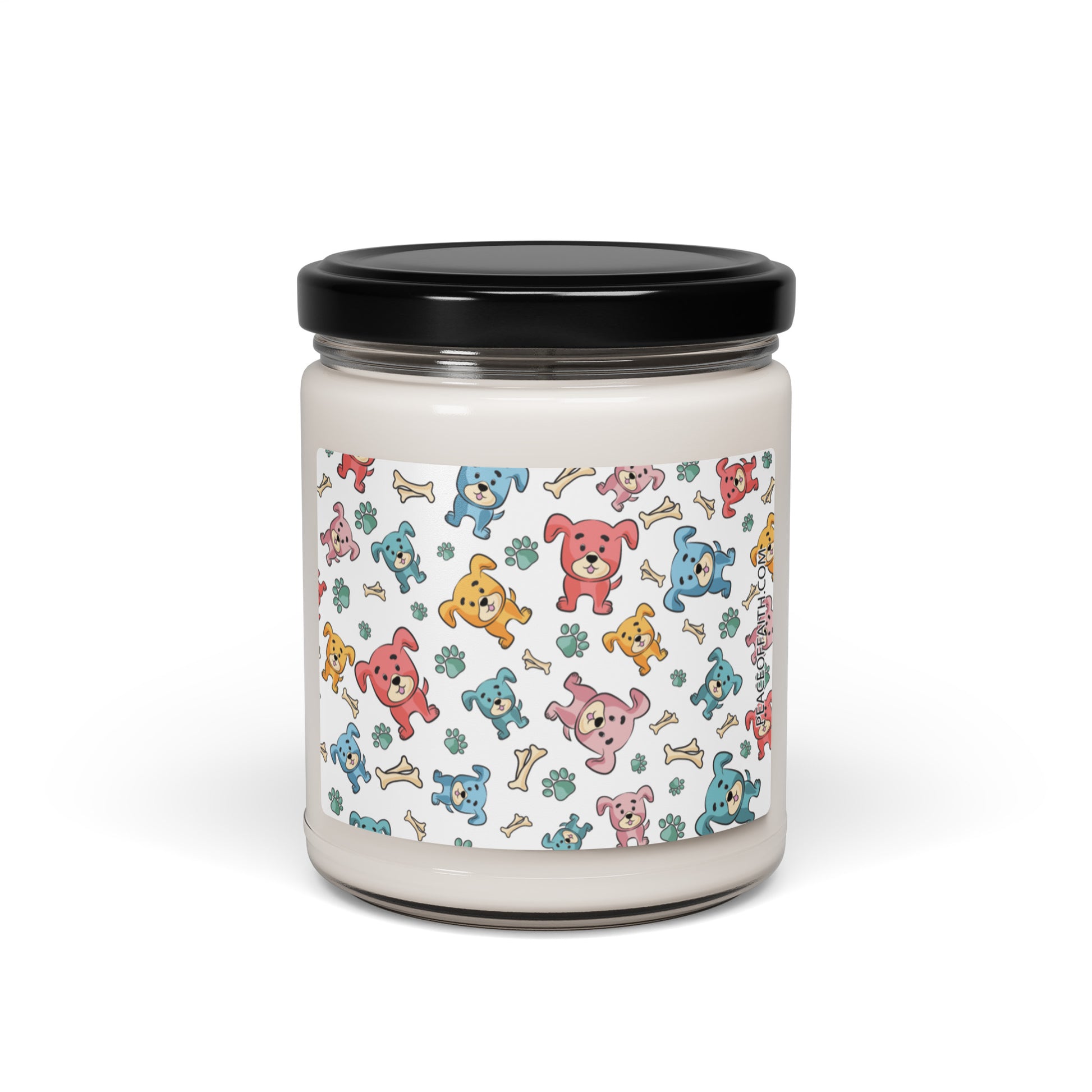 Clean cotton scented soy candle in a clear glass jar with multi-colored puppies with bones and paws tossed around on the front label.