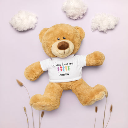 Personalized brown Teddy Bear wearing a white T-shirt that says  Jesus Loves Me with child's name and colorful cartoon little kids holding hands. 