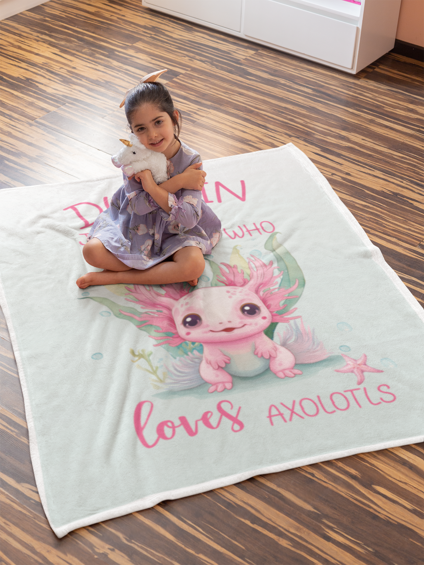 Personalized Just a Girl Who Loves Axolotls 50x60 Throw Blanket with little girl sitting on the blanket. 