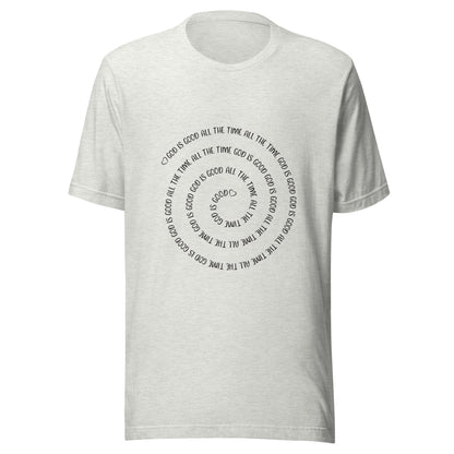 Ash gray short sleeve t-shirt that has a spiral of the words 'God is good all the time all the time God is good', with two small hearts one at the start of the spiral and one at the end in the middle.