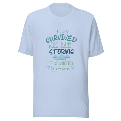 Baby blue unisex short sleeve t-shirt that states 'I have survived too many storms to be bothered by raindrops' with raindrops and storm clouds.