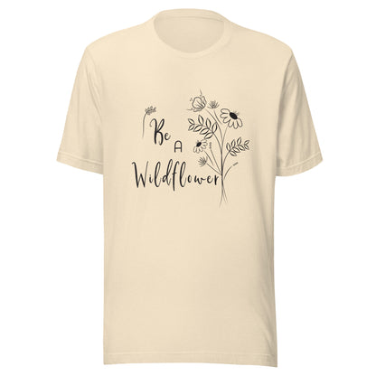 Heather natural unisex t-shirt that says 'Be a Wildflower' with wildflowers beside it black ink only.