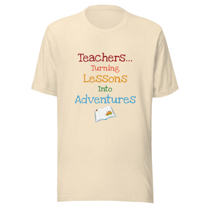 Short sleeve unisex t-shirt that says 'Teachers turning lessons into adventures' with an open book below writing. 
