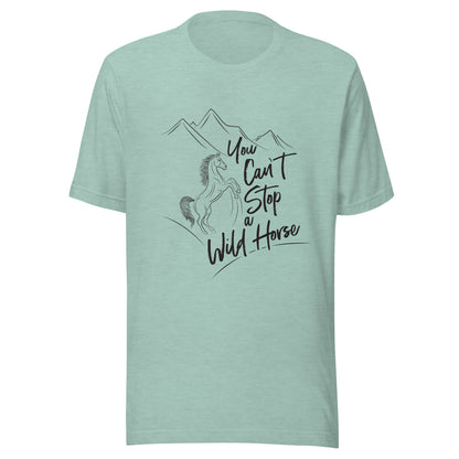 Heather prism dusty blue unisex short sleeve t-shirt that states 'You can't stop a wild horse' with a horse rearing up and mountains in the background.