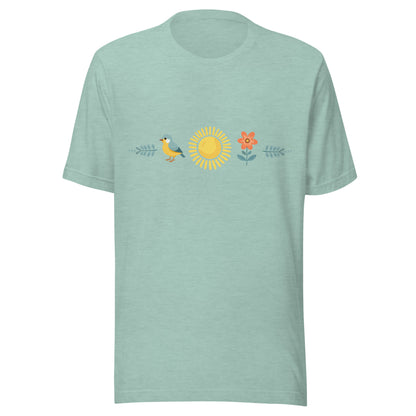 Heather prism dusty blue unisex t-shirt with a sun in the middle with a bird on one side and a flower on the other.