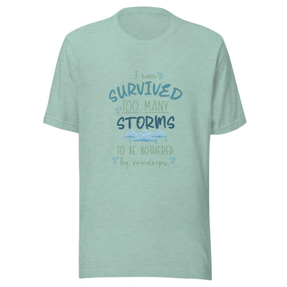Heather prism dusty blue unisex short sleeve t-shirt that states 'I have survived too many storms to be bothered by raindrops' with raindrops and storm clouds.