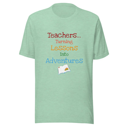 Short sleeve unisex t-shirt that says 'Teachers turning lessons into adventures' with an open book below writing. 