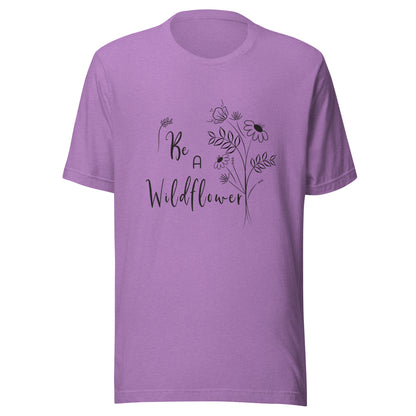 Heather purple unisex t-shirt that says 'Be a Wildflower' with wildflowers beside it black ink only.