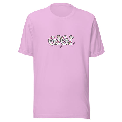 Lilac short sleeve unisex t-shirt that says Gigi on the front written in cute font with flowers inside each letter. 