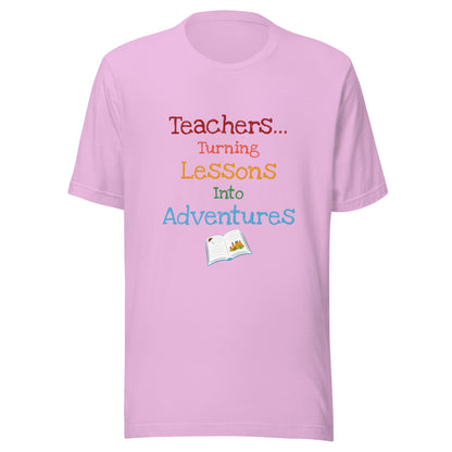 Short sleeve unisex t-shirt that says 'Teachers turning lessons into adventures' with an open book below writing.