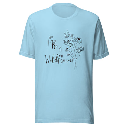 Ocean blue unisex t-shirt that says 'Be a Wildflower' with wildflowers beside it black ink only.