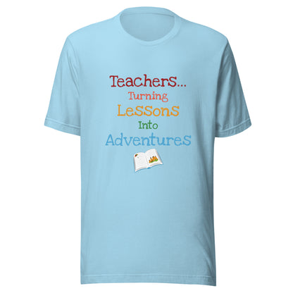 Short sleeve unisex t-shirt that says 'Teachers turning lessons into adventures' with an open book below writing. 