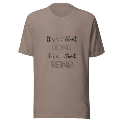 Pebble unisex short sleeve t-shirt that states It's not about doing it's all about being.