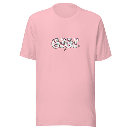 Pink short sleeve unisex t-shirt that says Gigi on the front written in cute font with flowers inside each letter. 