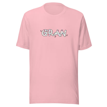 Pink short sleeve unisex t-shirt that says Gran on the front written in cute font with flowers inside each letter. 