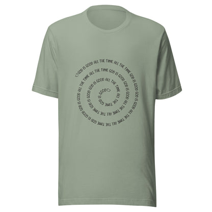 Sage short sleeve t-shirt that has a spiral of the words 'God is good all the time all the time God is good', with two small hearts one at the start of the spiral and one at the end in the middle.