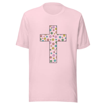 Soft pink unisex short sleeve t-shirt that has a multi-colored polka dot cute cross on the front. 