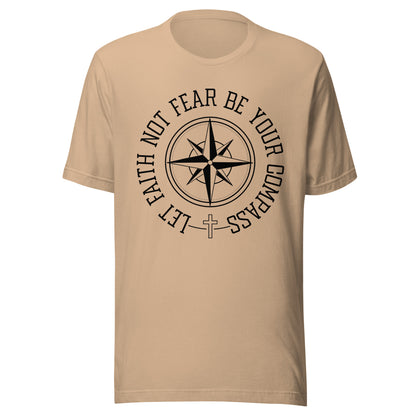 Tan unisex short sleeve t-shirt surrounding a compass are the words let faith not fear be your compass.