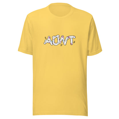 Yellow short sleeve unisex t-shirt that says Aunt on the front written in cute font with flowers inside each letter. 
