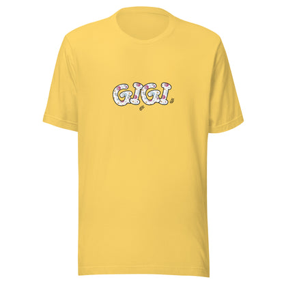 Yellow short sleeve unisex t-shirt that says Gigi on the front written in cute font with flowers inside each letter. 