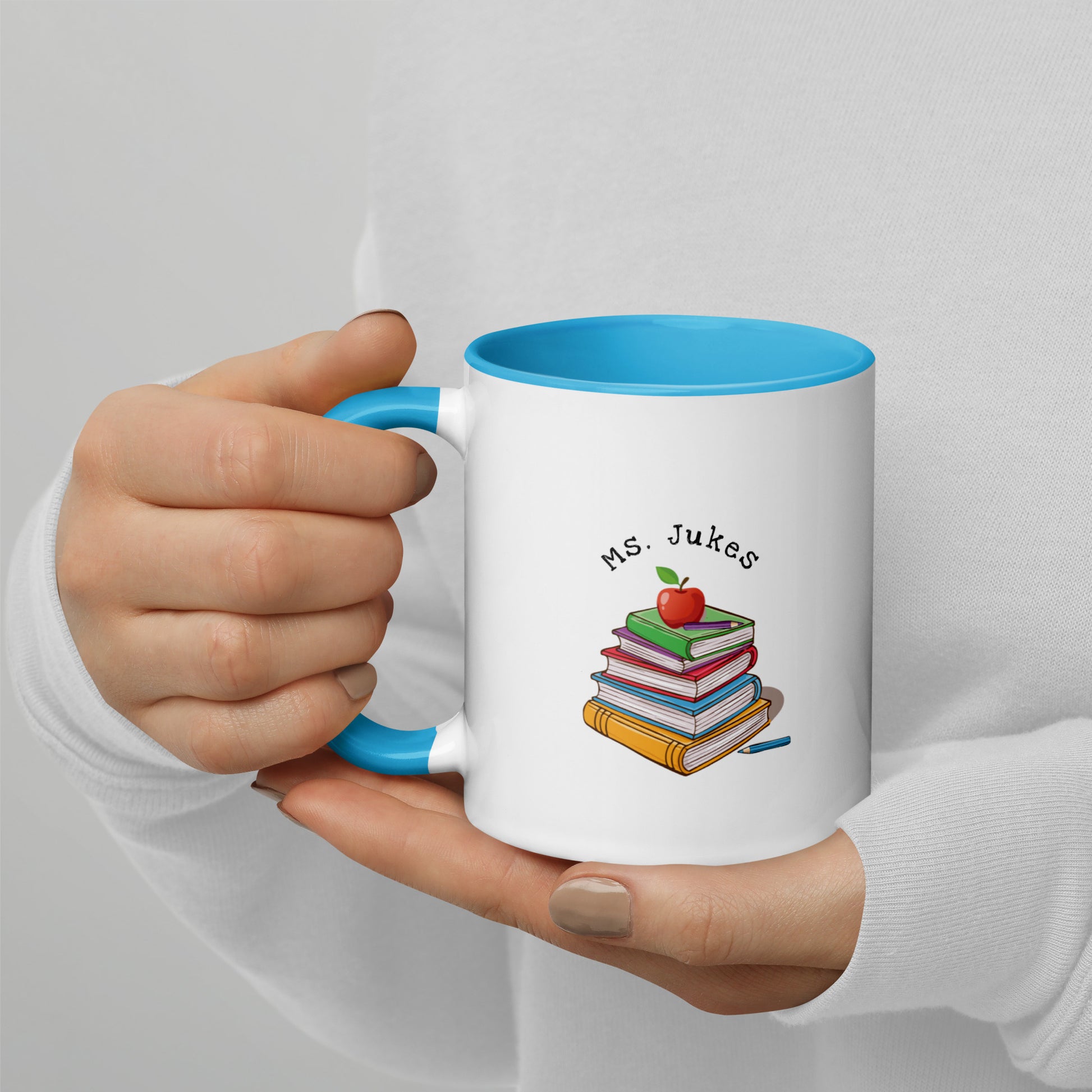 Personalized with Teacher name that says Turning Lessons Into Adventure printed on both sides on white Ceramic Mug with blue color handle and inside of mug.