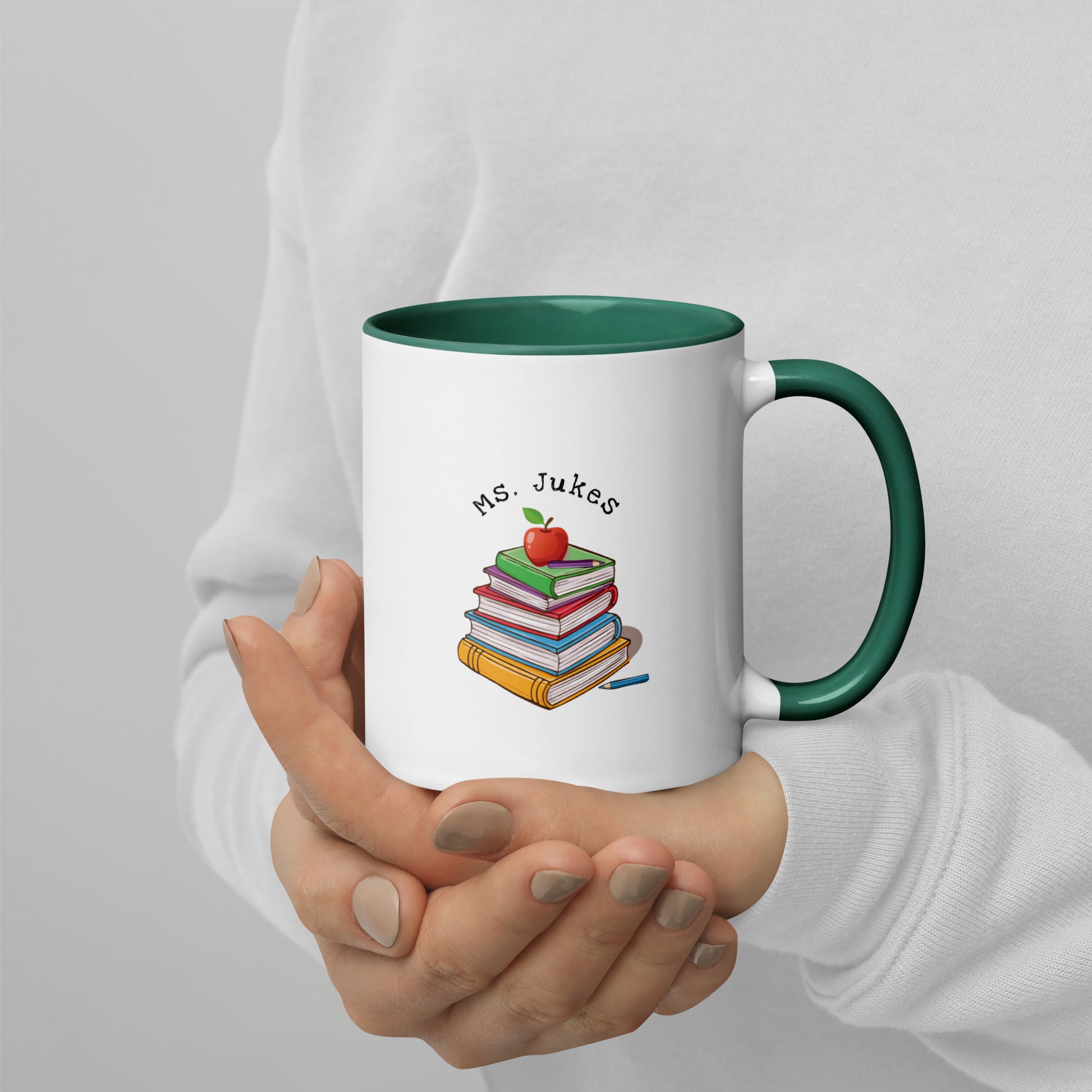 Personalized with Teacher name that says Turning Lessons Into Adventure printed on both sides on white Ceramic Mug with green color handle and inside of mug.