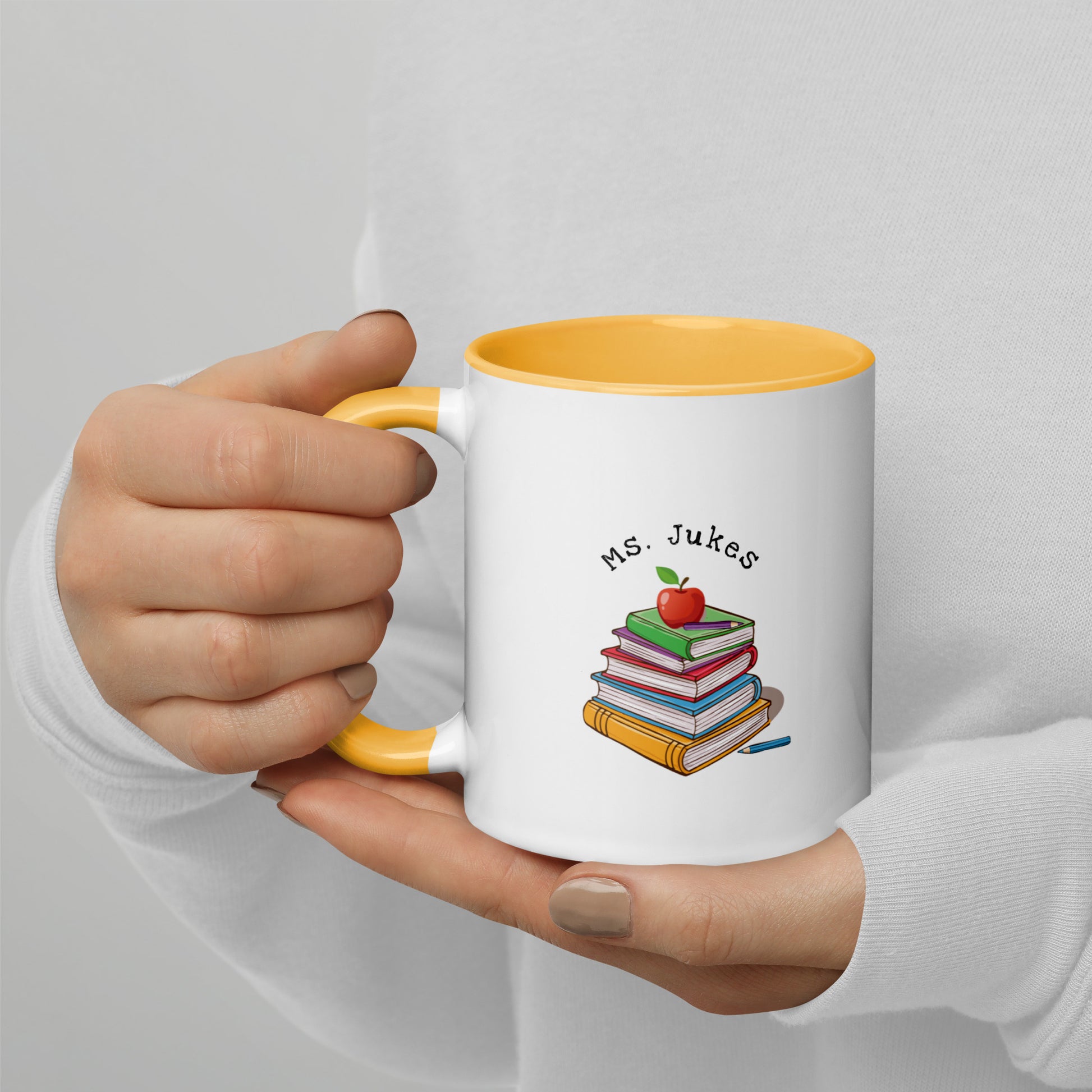 Personalized with Teacher name that says Turning Lessons Into Adventure printed on both sides on white Ceramic Mug with yellow color handle and inside of mug.