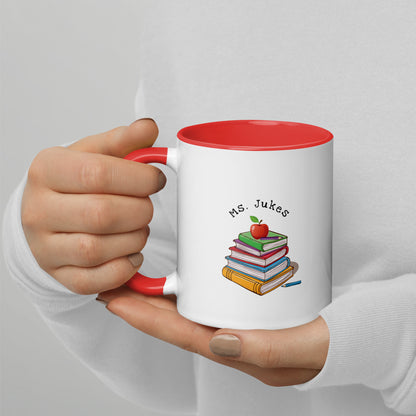 Personalized with Teacher name that says Turning Lessons Into Adventure printed on both sides on white Ceramic Mug with red color handle and inside of mug.