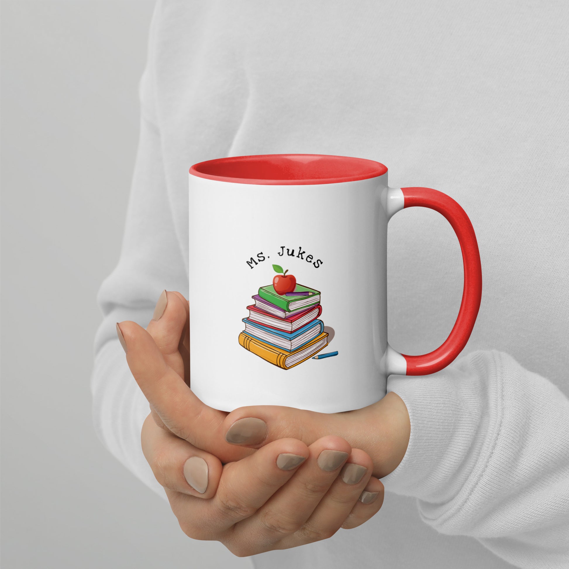 Personalized with Teacher name that says Turning Lessons Into Adventure printed on both sides on white Ceramic Mug with red color handle and inside of mug.